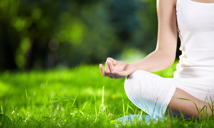 Woman meditating on the grass